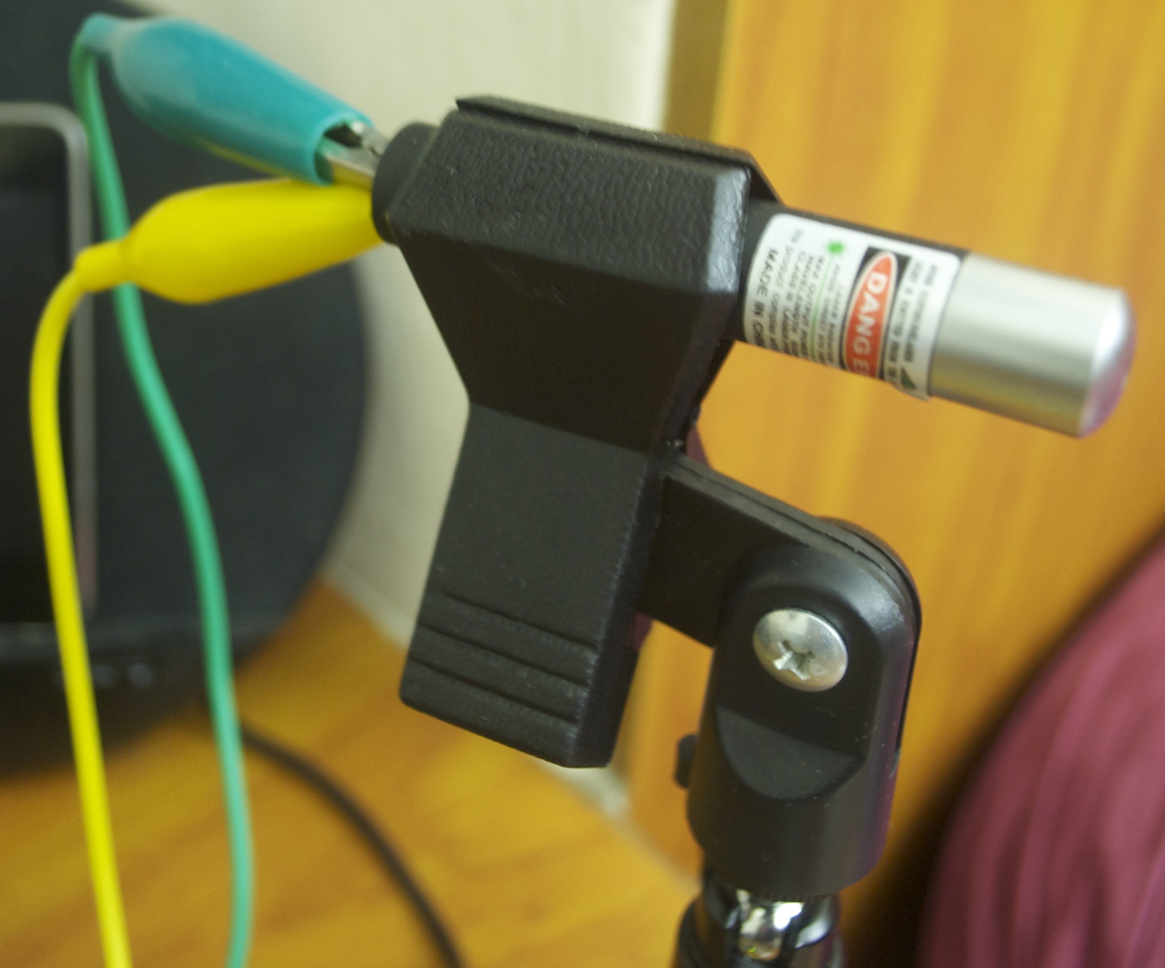 The laser pointer. It's held in a microphone clip mounted on a tiny tripod.