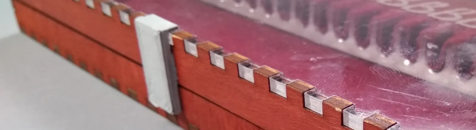 The latch is glued onto the box.
