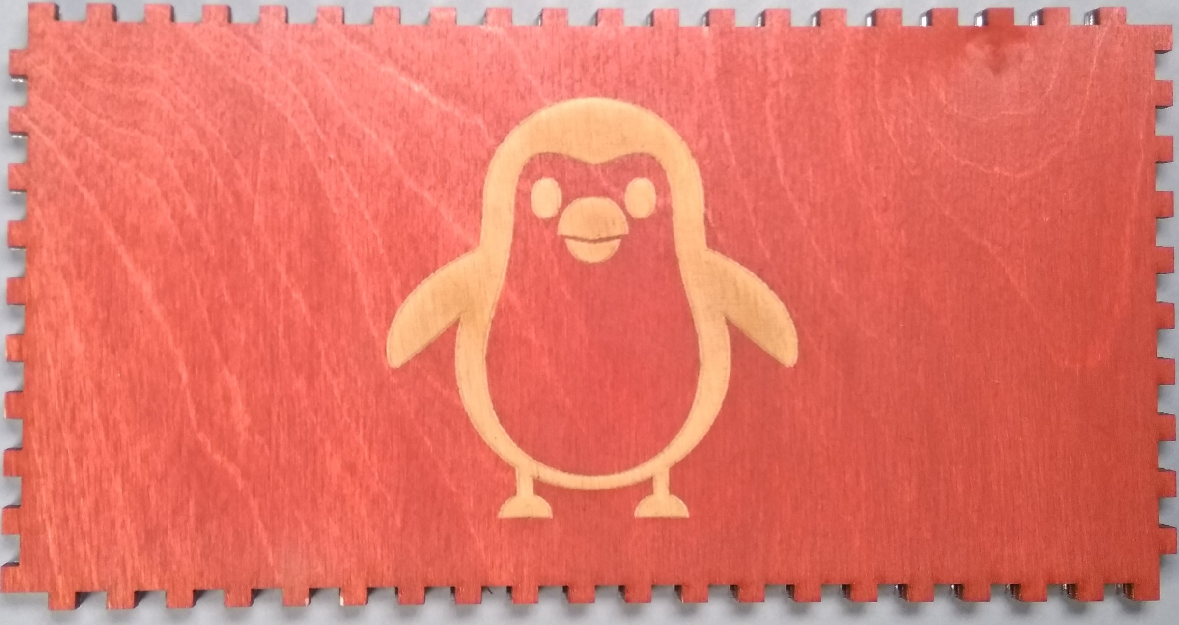 We raster engrave a penguin on the bottom of the box.